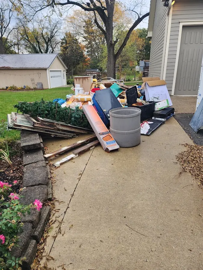 Dumpster being loaded with debris for Commercial Dumpster Rental in Water Valley